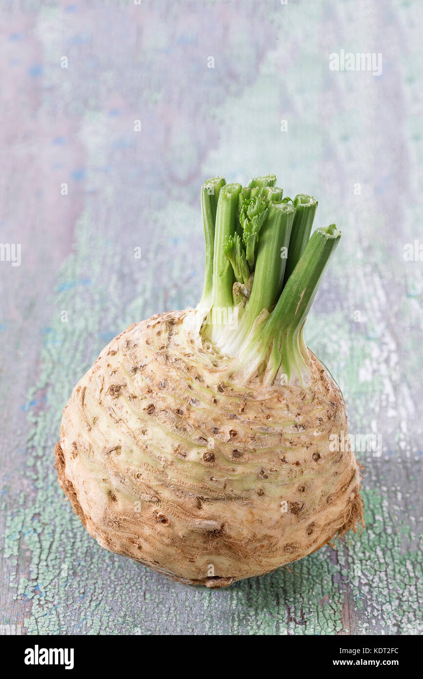 fresh celery root isolated on old paint green wooden board background Stock Photo
