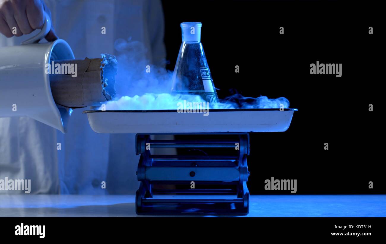 Bottle and liquid nitrogen in a laboratory. Chemical experiment. Flask