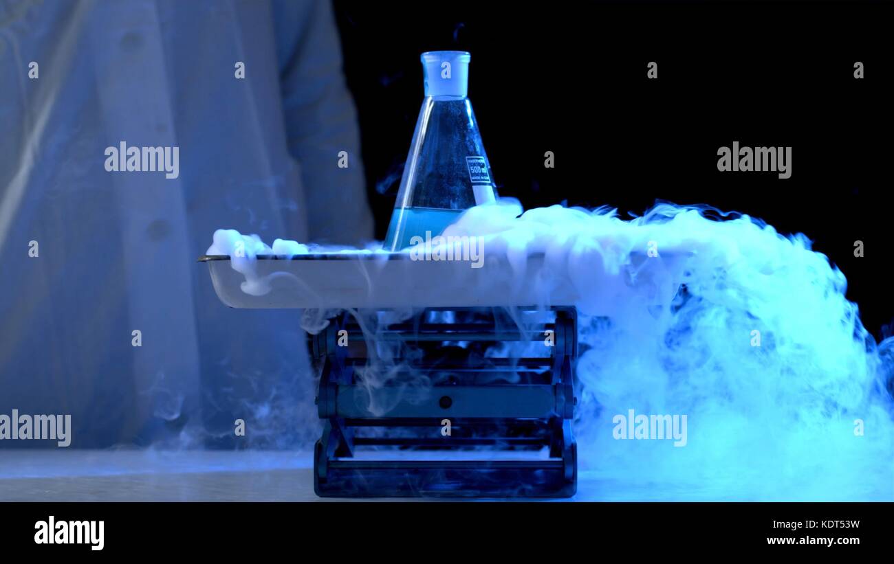 Bottle and liquid nitrogen in a laboratory. Chemical experiment. Flask