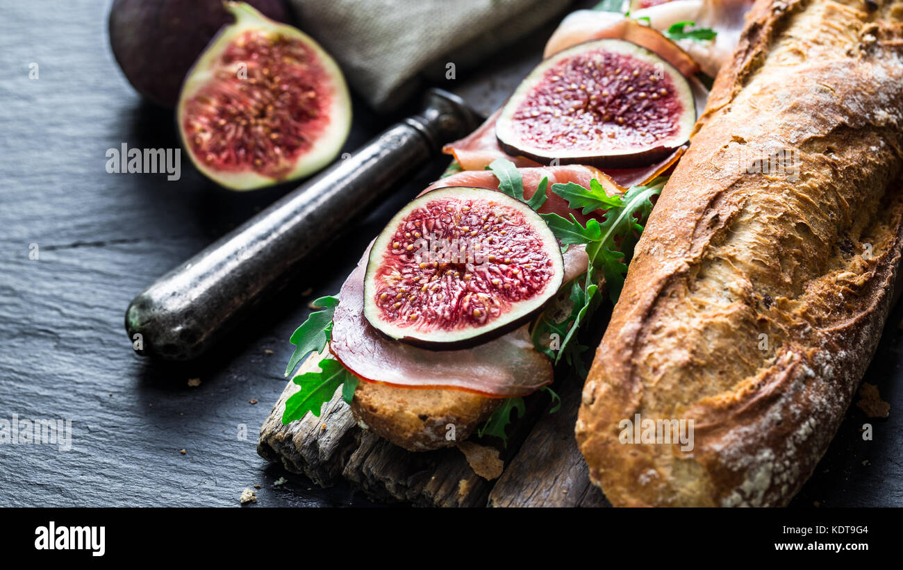 Baguette sandwich with figs, prosciutto and arugula Stock Photo Alamy
