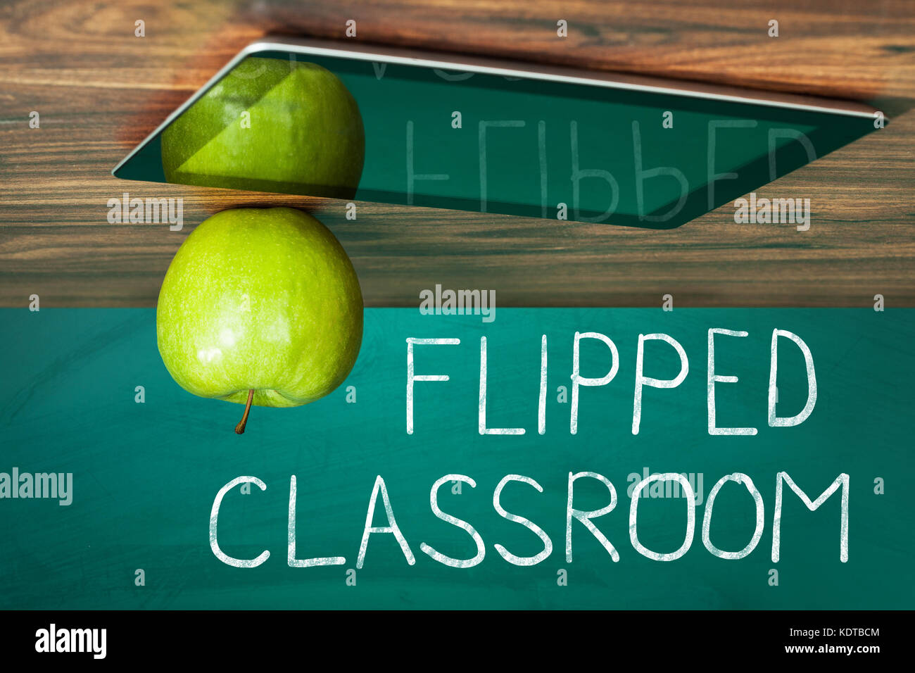 Flipped Classroom Concept On Blackboard With Apple And Digital Tablet On Wooden Table Stock Photo