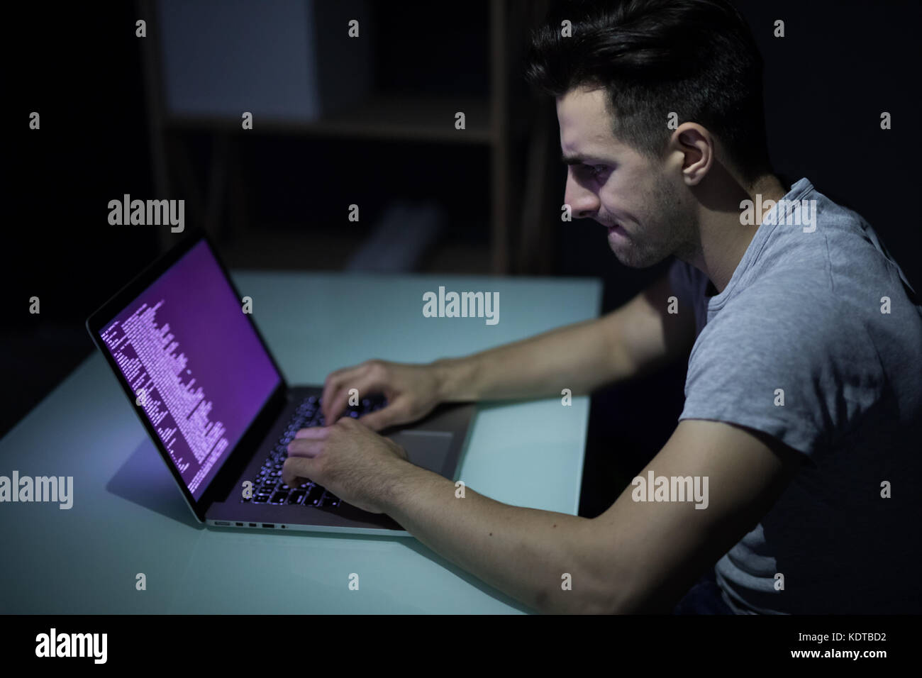 Russian hacker hacking the server in the dark Stock Photo