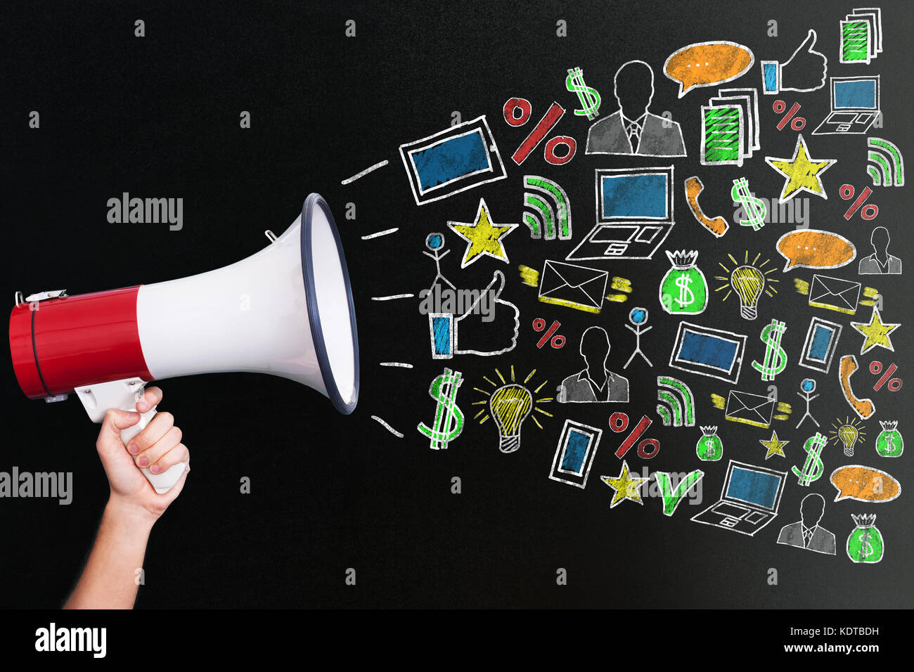 Hand Holding Megaphone With Different Icons For Digital Marketing Concept On Blackboard Stock Photo