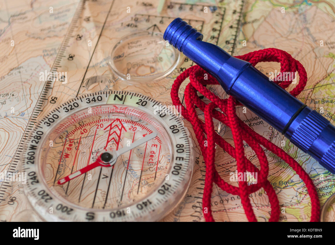 Compass showing direction on Topographic Map with Rescue Whistle