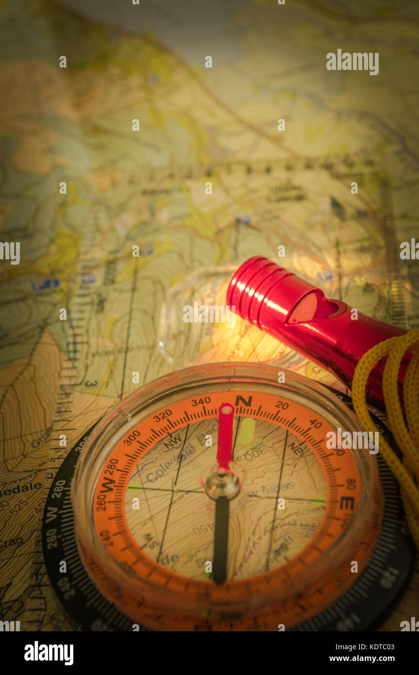 Compass showing direction on Topographic Map with Rescue Whistle, Navigating at Night, Flash