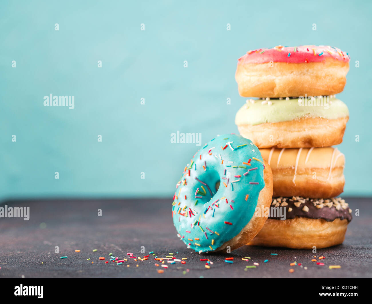 Stack of assorted donuts, copy space Stock Photo - Alamy