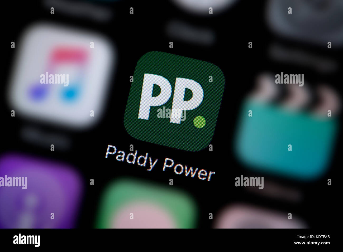 A close-up shot of the logo representing the Paddy Power app icon, as seen on the screen of a smart phone (Editorial use only) Stock Photo