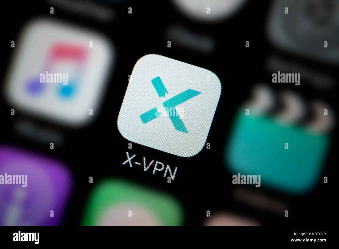 A close-up shot of the logo representing the X-VPN app icon, as seen on the screen of a smart phone (Editorial use only) Stock Photo