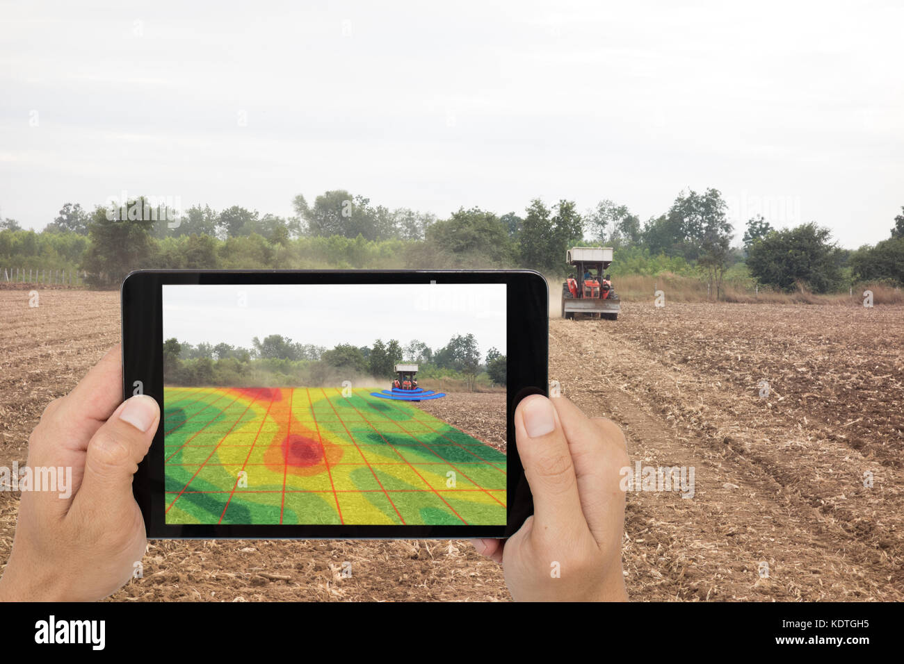 smart agriculture concept, farmer use tablet read infrared in tractor