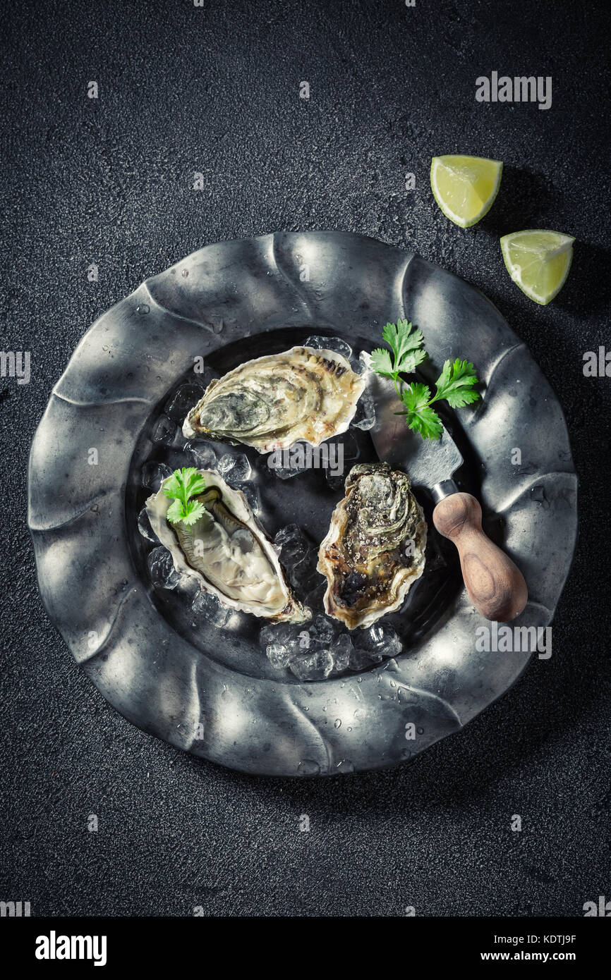 Fresh and delicious oysters with coriander and lemons Stock Photo Alamy