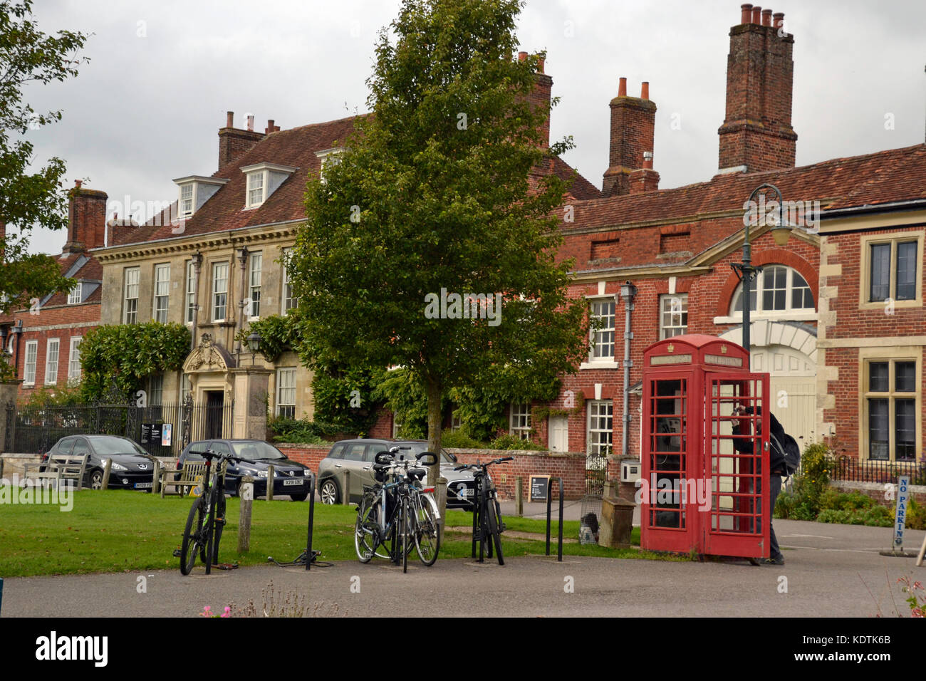 Salisbury, Wiltshire, UK - view of old style red telephone box with Mompesson House in background. Stock Photo