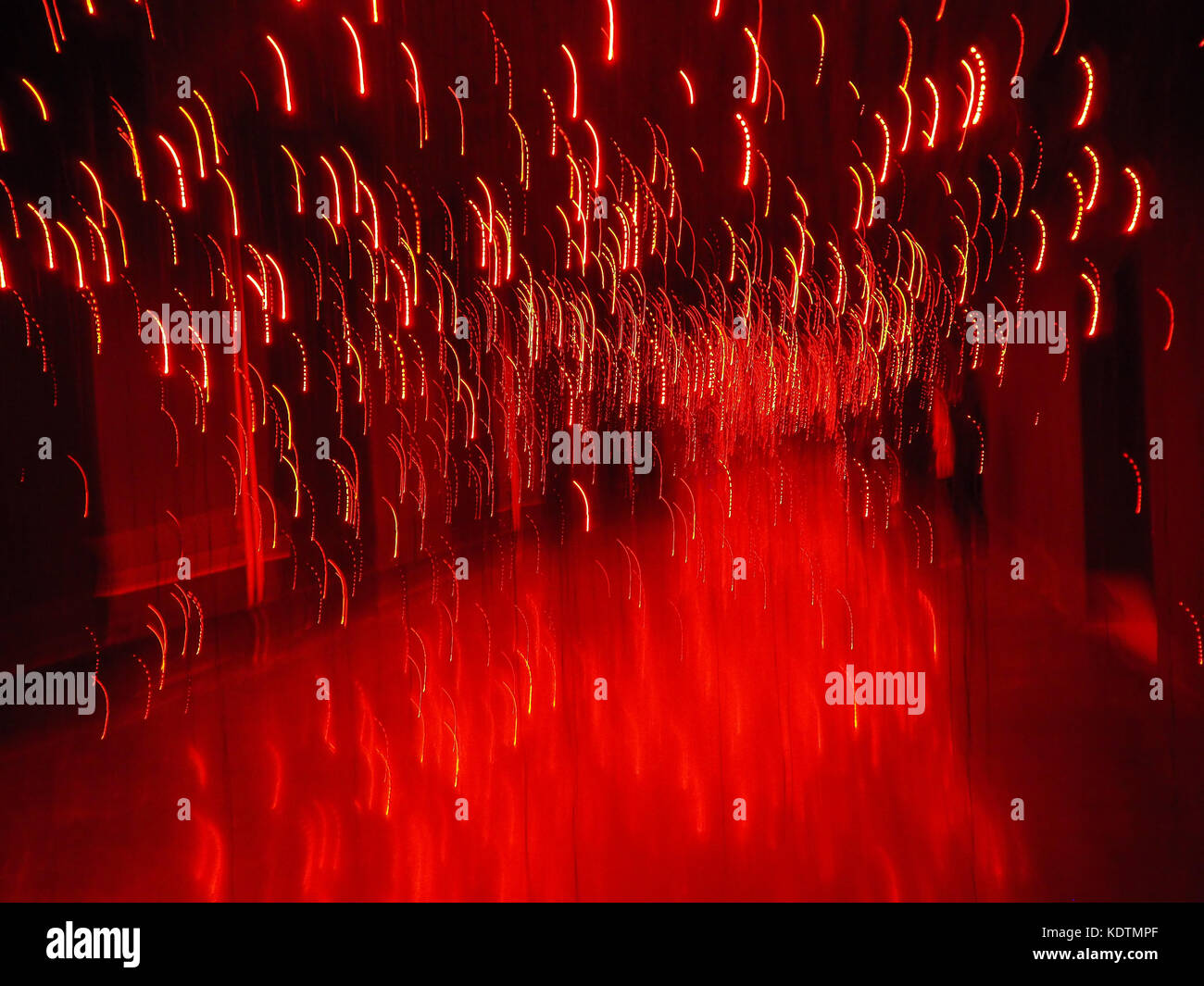 Red shining background lights with motion blur on black backdrop; template/texture with copy space; landscape format Stock Photo
