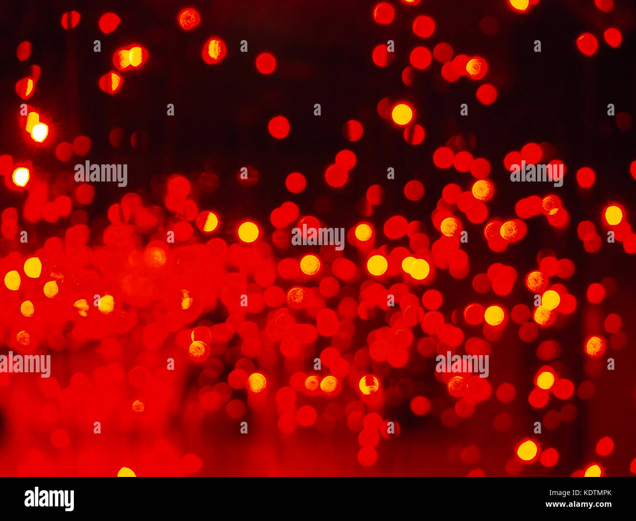 Abstract red bokeh background of night lights; template/texture with