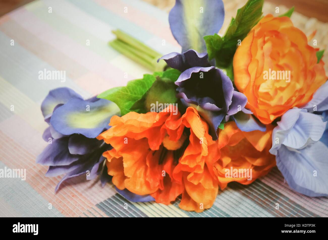 Bunch of Artificial Orange Ranunculus Flowers with Blue Flowers on A