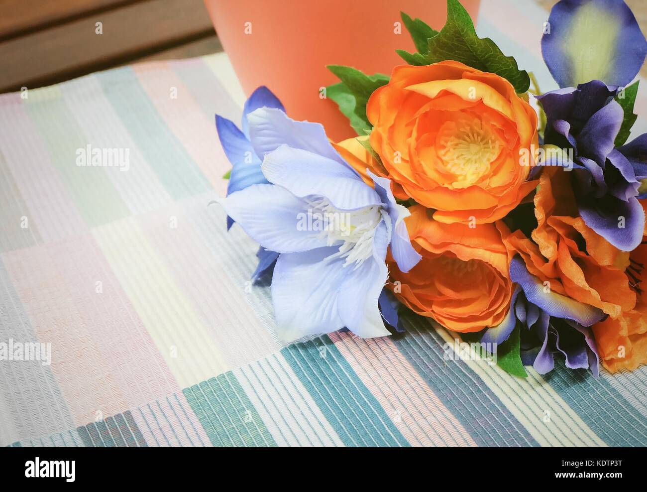 Bunch of Artificial Orange Ranunculus Flowers with Blue Flowers on A