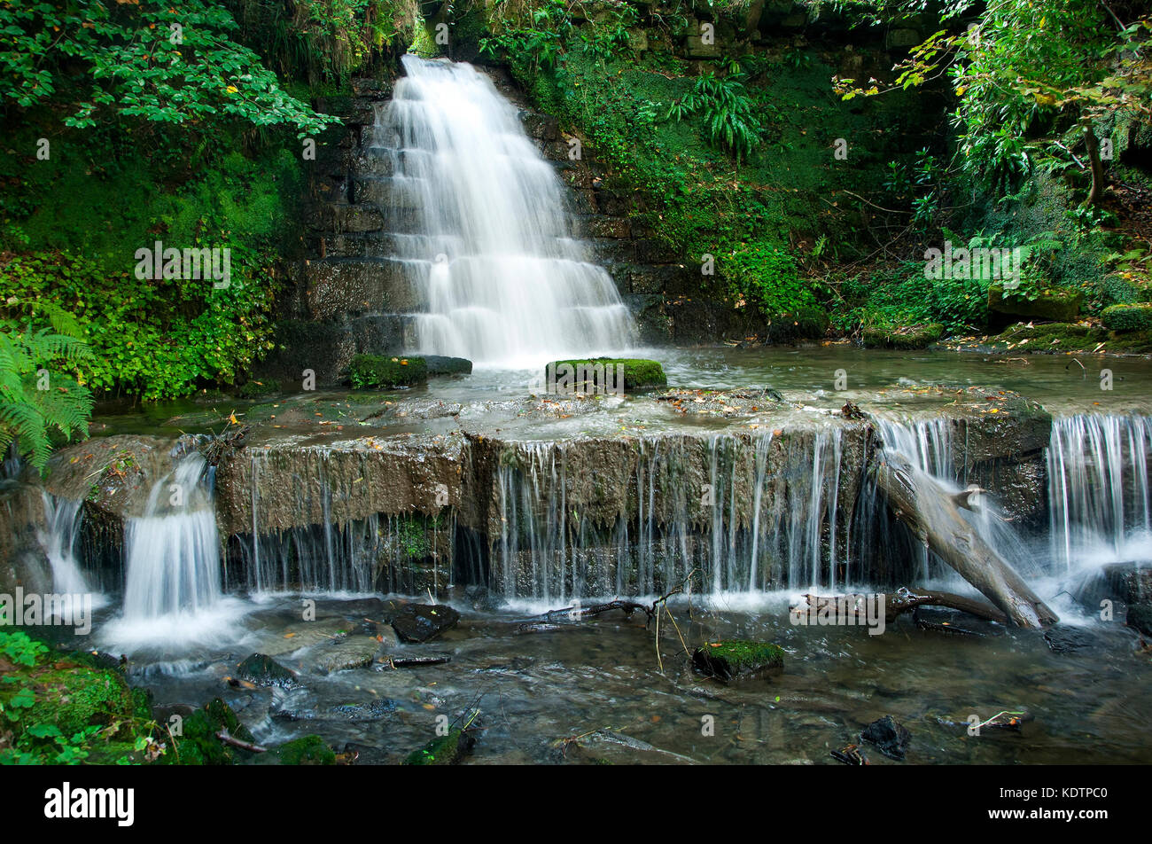 A small waterfall at Rouken Glen Park, Giffnock. Stock Photo