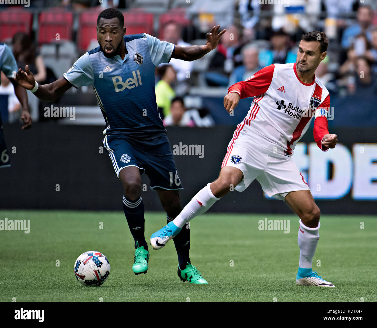 Vancouver, Canada. 15th Oct, 2017. Tony Tchani (L) of Vancouver Whitecaps vies with Chris Wondolowski of San Jose Earthquakes during the MLS regular season match between Vancouver Whitecaps and San Jose Earthquakes at BC Place Stadium in Vancouver, Canada, on Oct. 15, 2017. The match ended with a 1-1 draw. Credit: Andrew Soong/Xinhua/Alamy Live News Stock Photo