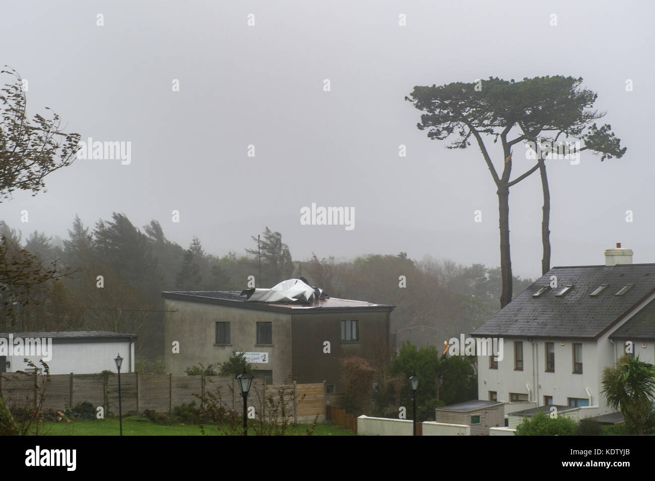 Schull, Ireland. 16th Oct, 2017. UK Weather.  Ex-Hurricane Ophelia hits Schull, Ireland with winds of 80kmh and gusts of 130kmh.  Major structural damage is expected as the worst is yet to come. The roof of the Schull Irish Coast Guard building is pictured partially blown off due to the high winds. Credit: Andy Gibson/Alamy Live News. Stock Photo