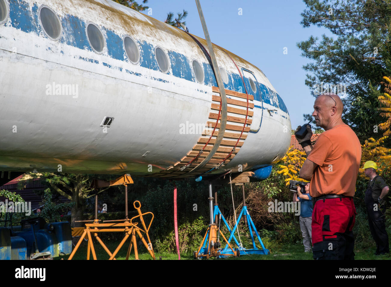 After months of preparation, airplane experts load the fuselage of a ...