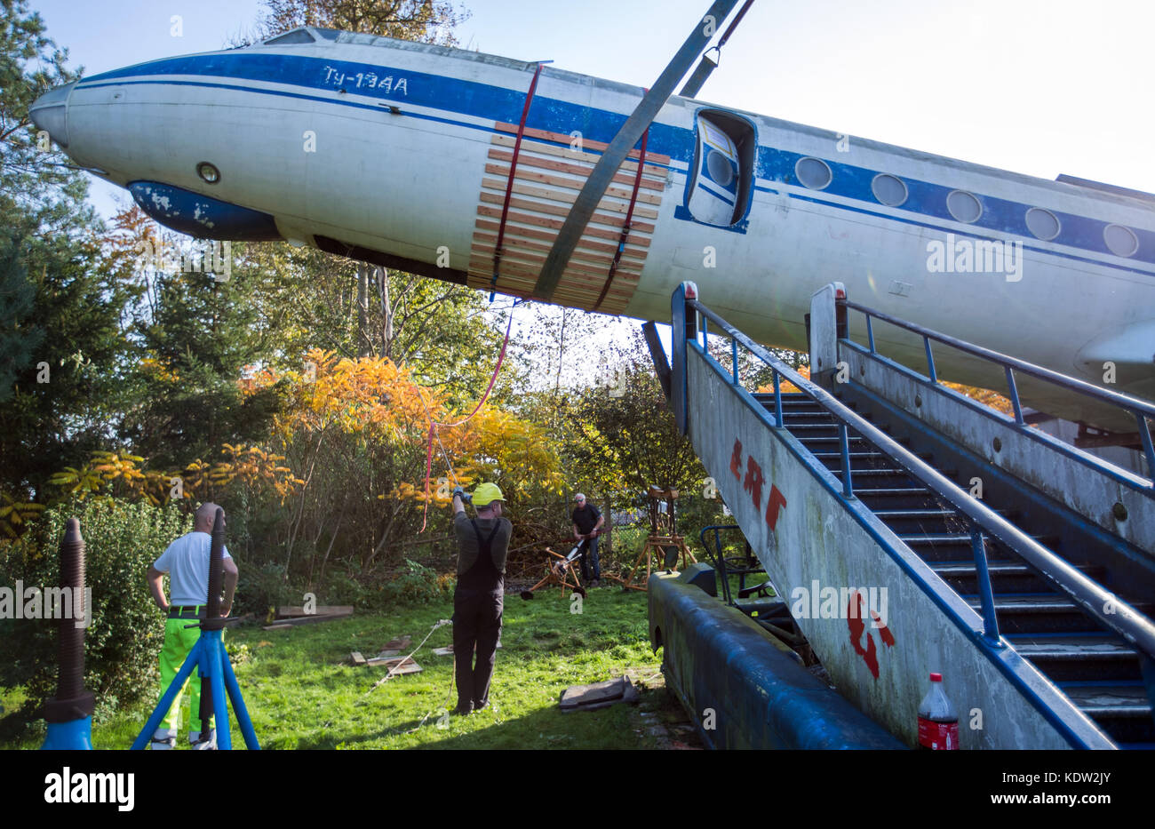 After months of preparation, airplane experts load the fuselage of a ...