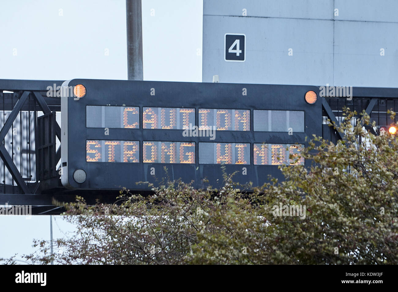 Newtownabbey, Northern Ireland. 16th October, 2017. Caution Strong Winds sign on M2 motorway at rush hour as peak of Storm Ophelia hits Northern Ireland. Glengormley, County Antrim, Northern Ireland, 16th October 2017. Credit: Radharc Images/Alamy Live News Stock Photo