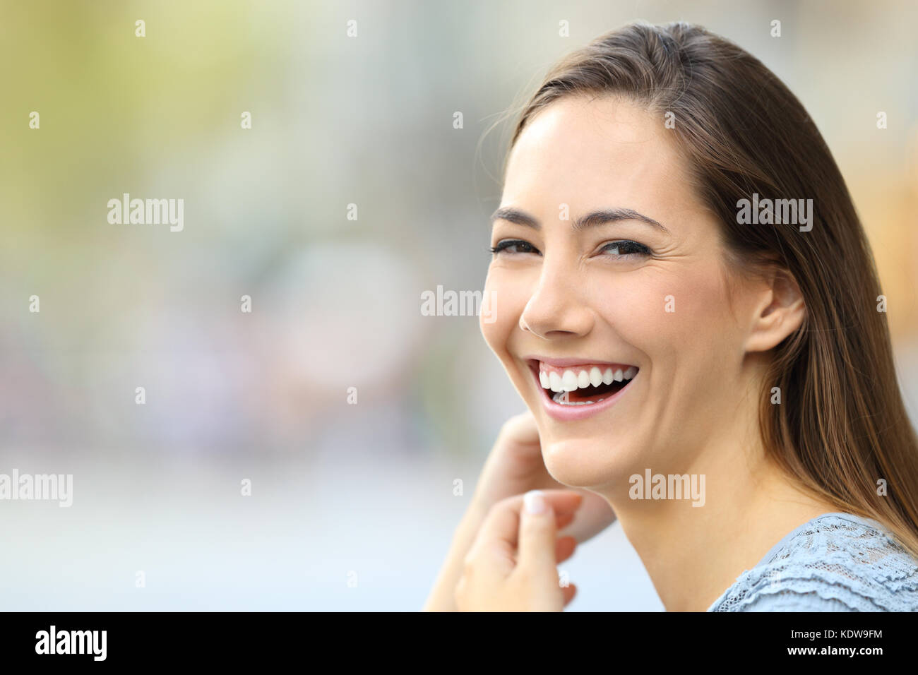 Portrait of a happy woman smiling looking at camera on the street Stock Photo