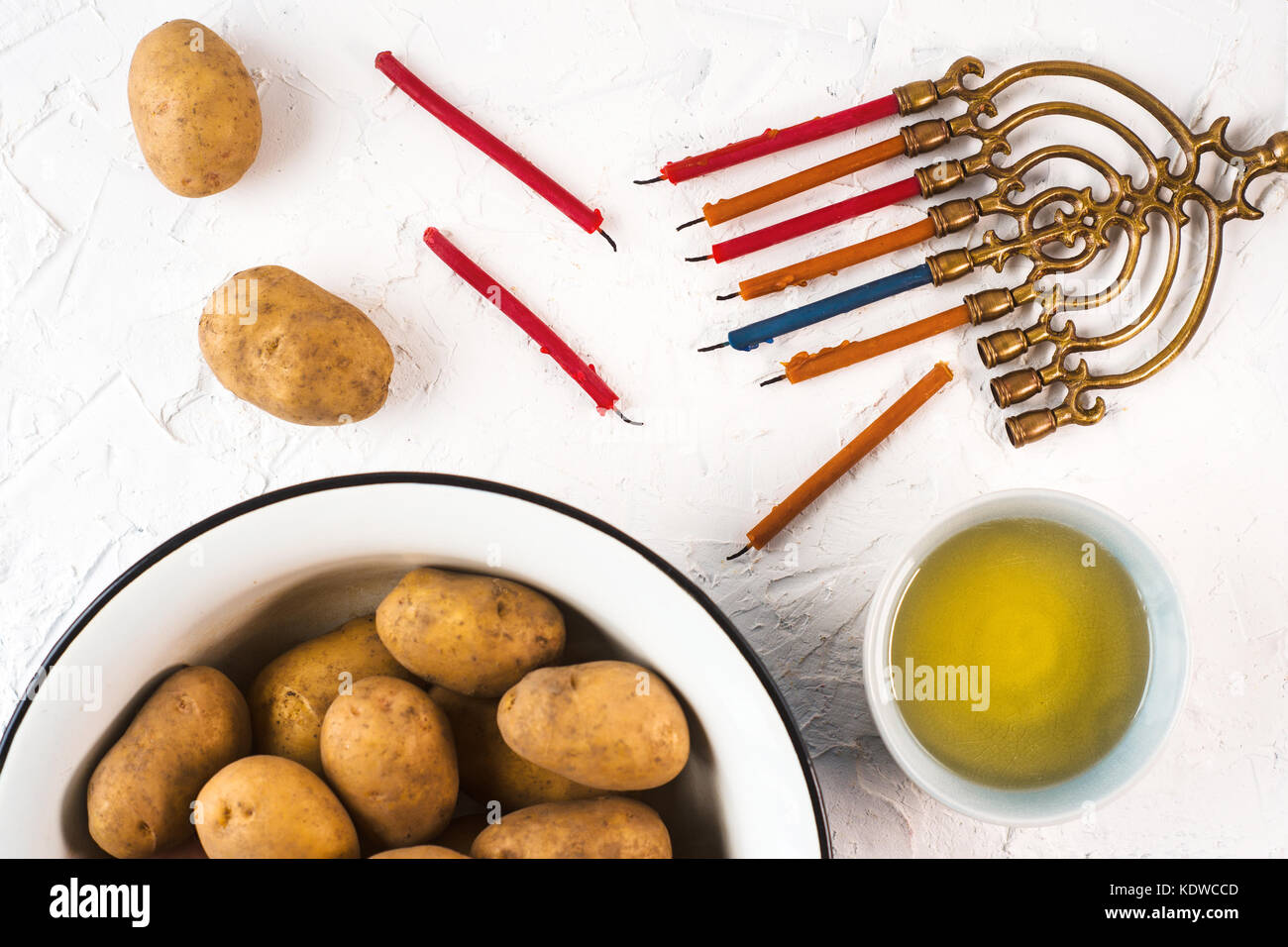 Hanukkah, olive oil and potatoes on a white background horizontal Stock Photo
