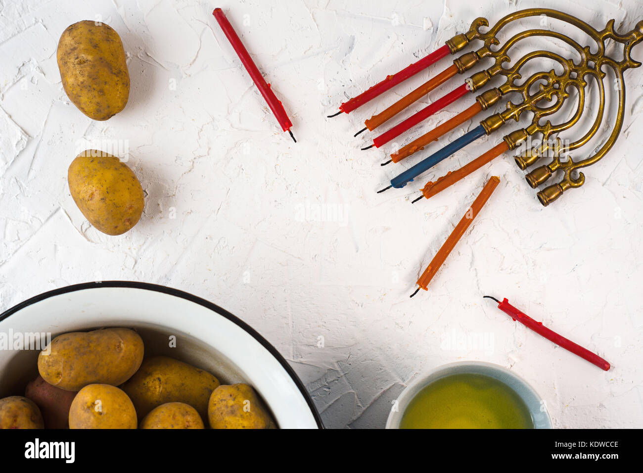 Frame of Hanukkah, olive oil and potatoes on a white background horizontal Stock Photo