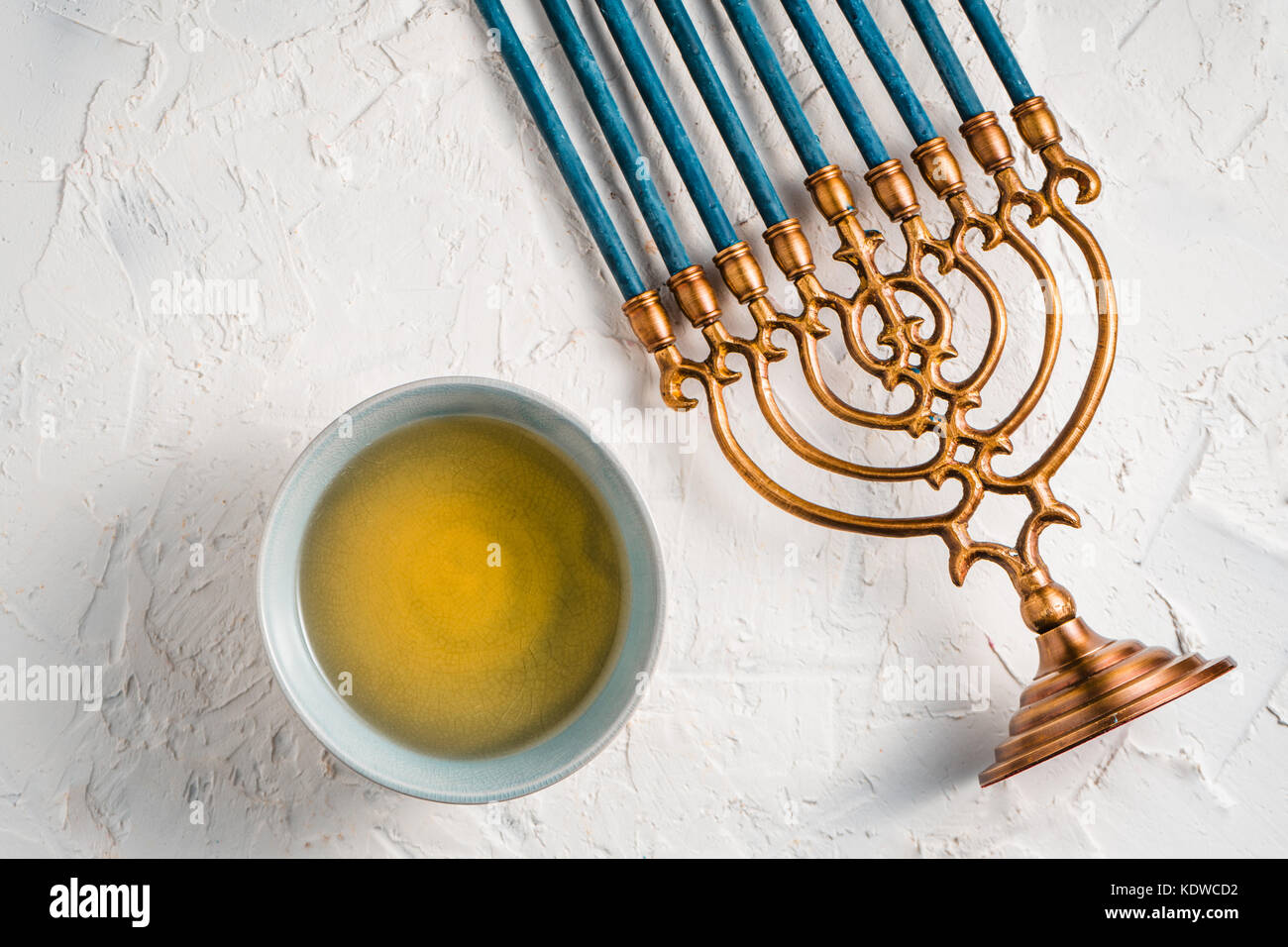 Fragment of Hanukkah with blue candles and butter in a bowl top view horizontal Stock Photo