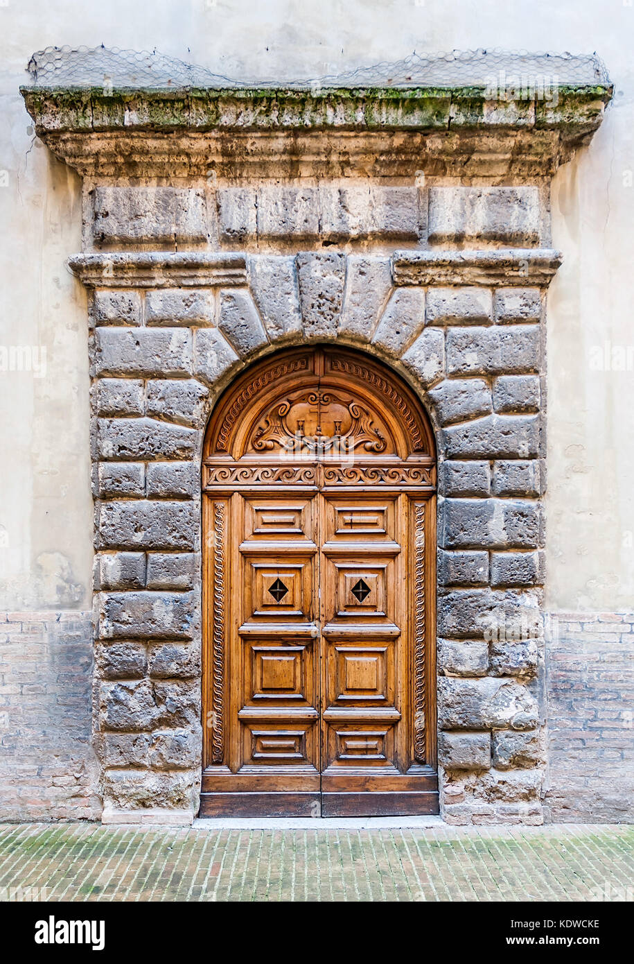 The renaissance town of Urbino, Marche, Italy. A door detail of the Ducale Palace (Palazzo Ducale) in Urbino city, Marche, Italy Stock Photo