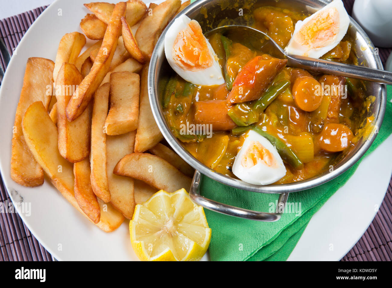 English pub meal of Curried Sausage with boiled egg served in a kahari