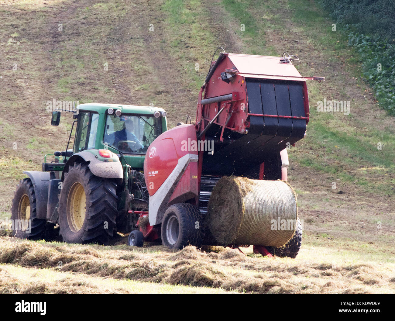John Deere 6930 Tractor Baling hay with Lely Welger RP160 V Baler Stock