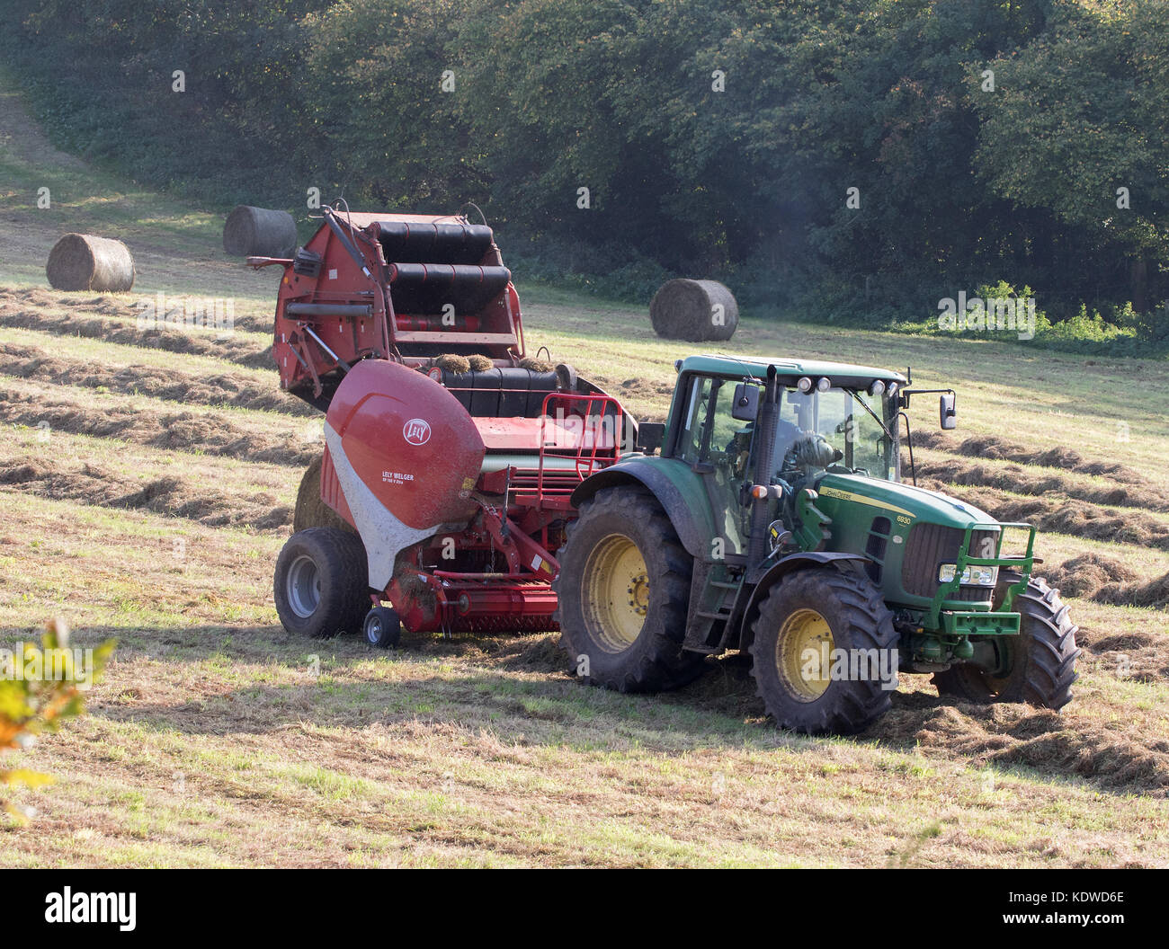John Deere 6930 Tractor Baling hay with Lely Welger RP160 V Baler Stock