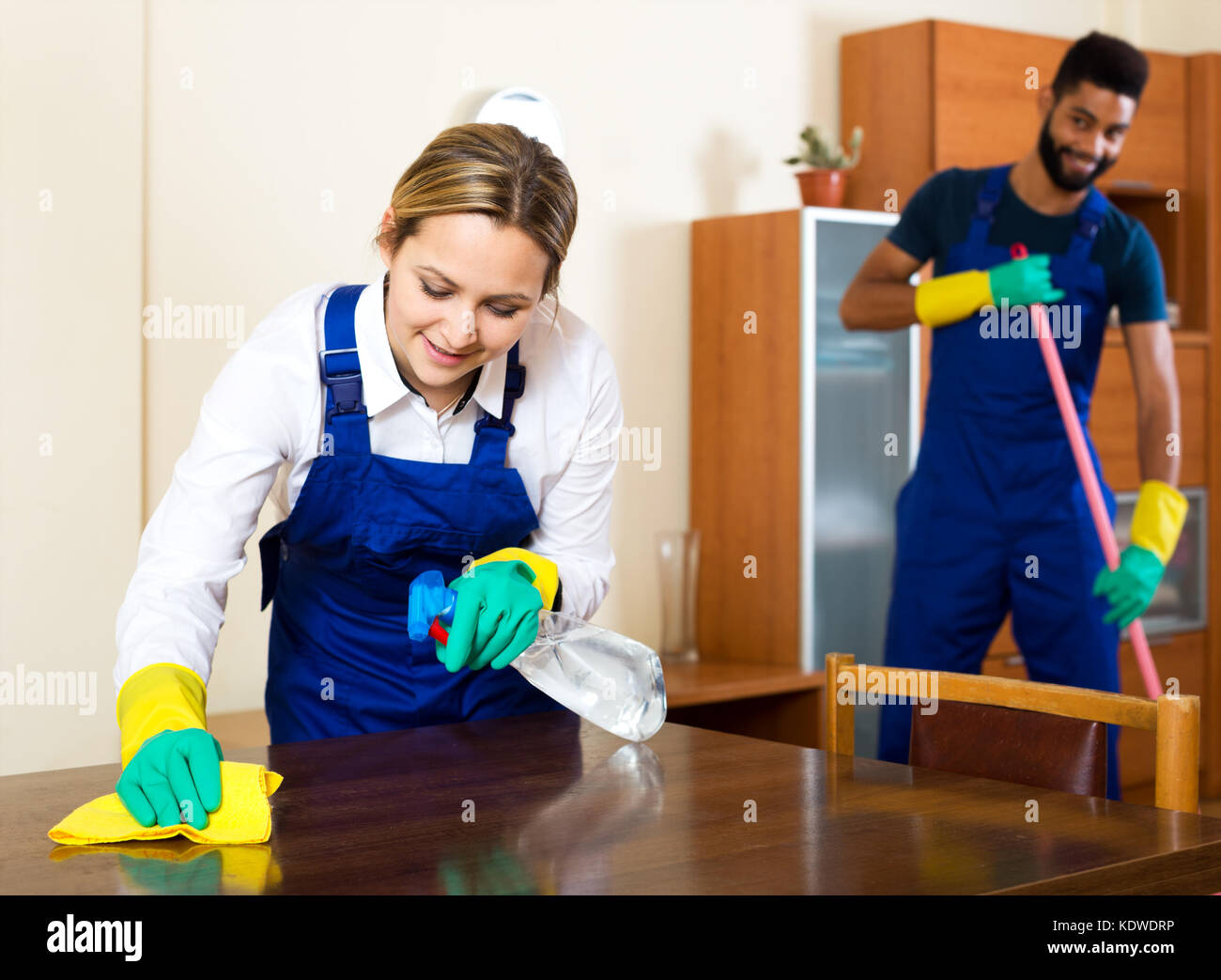 Young professional cleaners cleaning and dusting at home Stock Photo