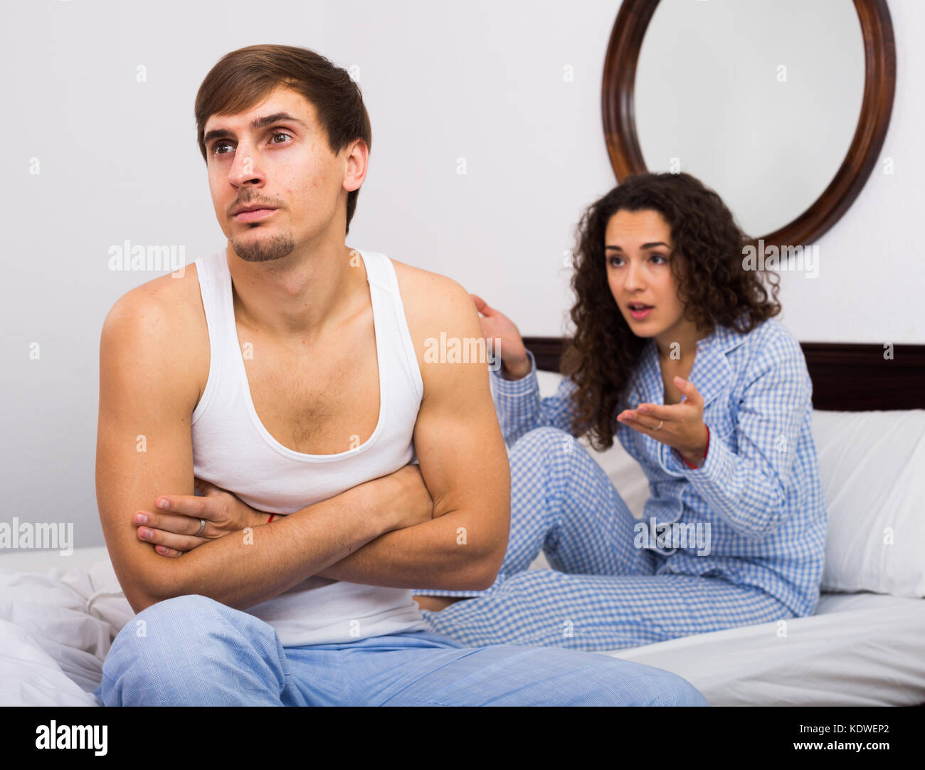 Husband turning away from wife during bad fight in bedroom Stock Photo photo