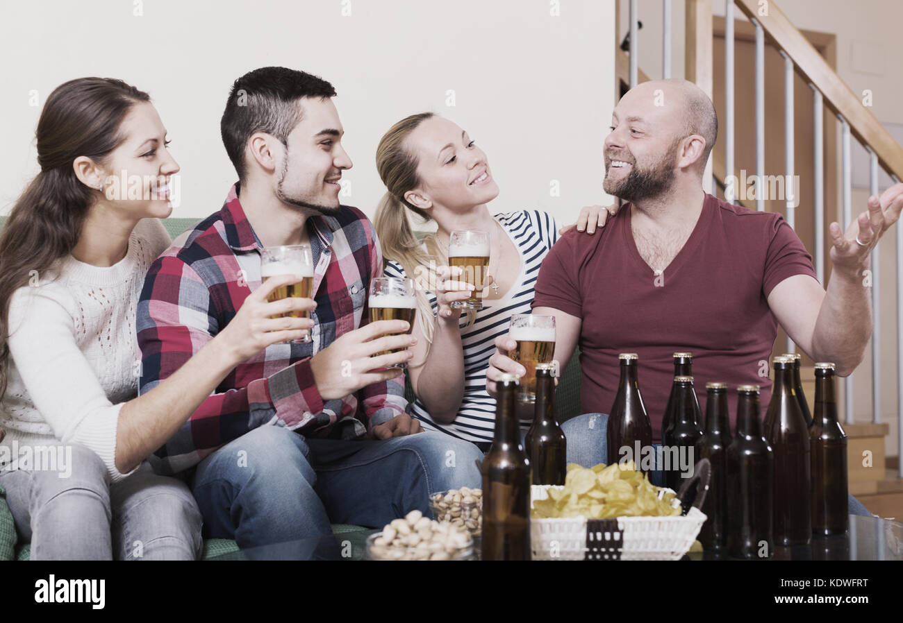 Two happy couples having fun at house party together Stock Photo - Alamy