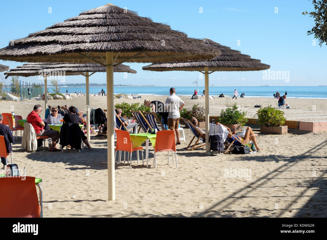 People relaxing at the Blue Moon snack bar on the beach, Venice Lido, Venice, Italy Stock Photo