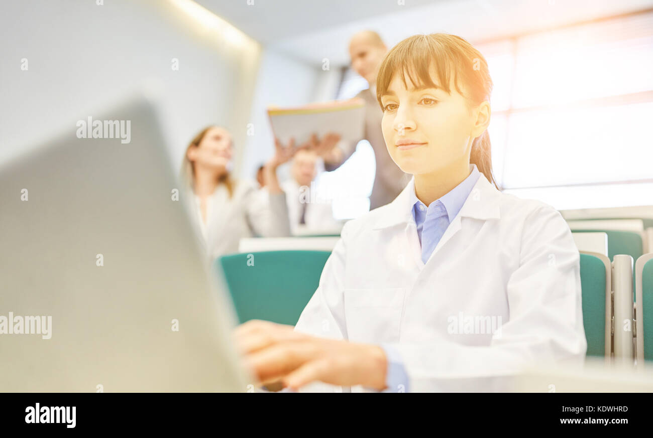Woman as student in physician training with laptop in medical school hall Stock Photo