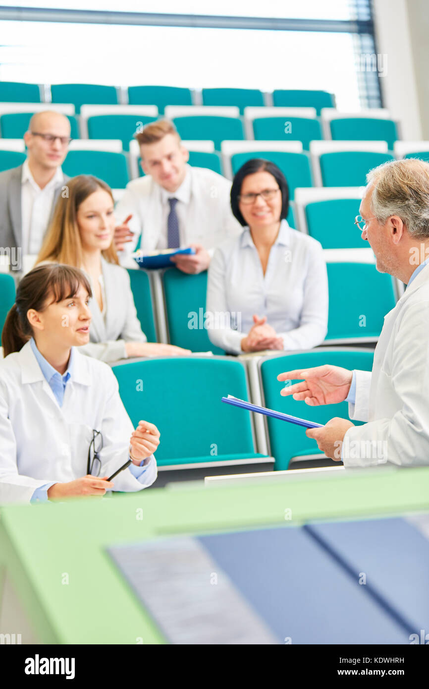 Medicine teacher ask student during exam in medical school Stock Photo
