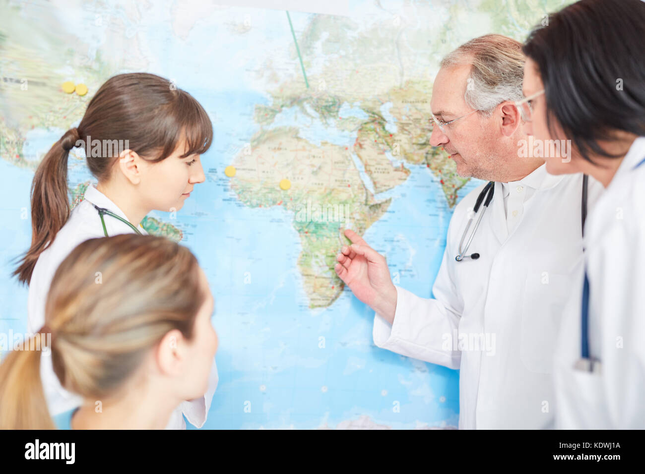 Team of doctors with world map plan relief action in Africa Stock Photo