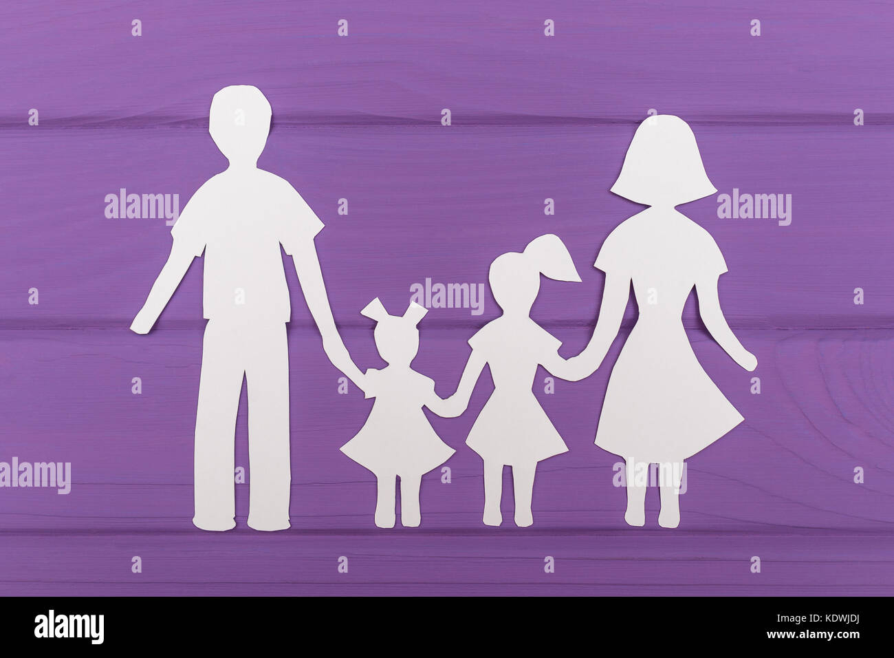 The silhouettes cut out of paper of man and woman with two girls on ...