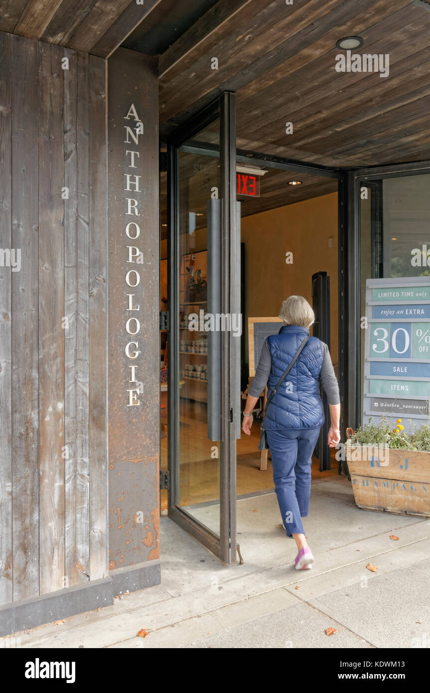 Woman entering Anthropologie women's clothing and accessories and home decor store on South Granville Street, Vancouver, BC, Canada Stock Photo