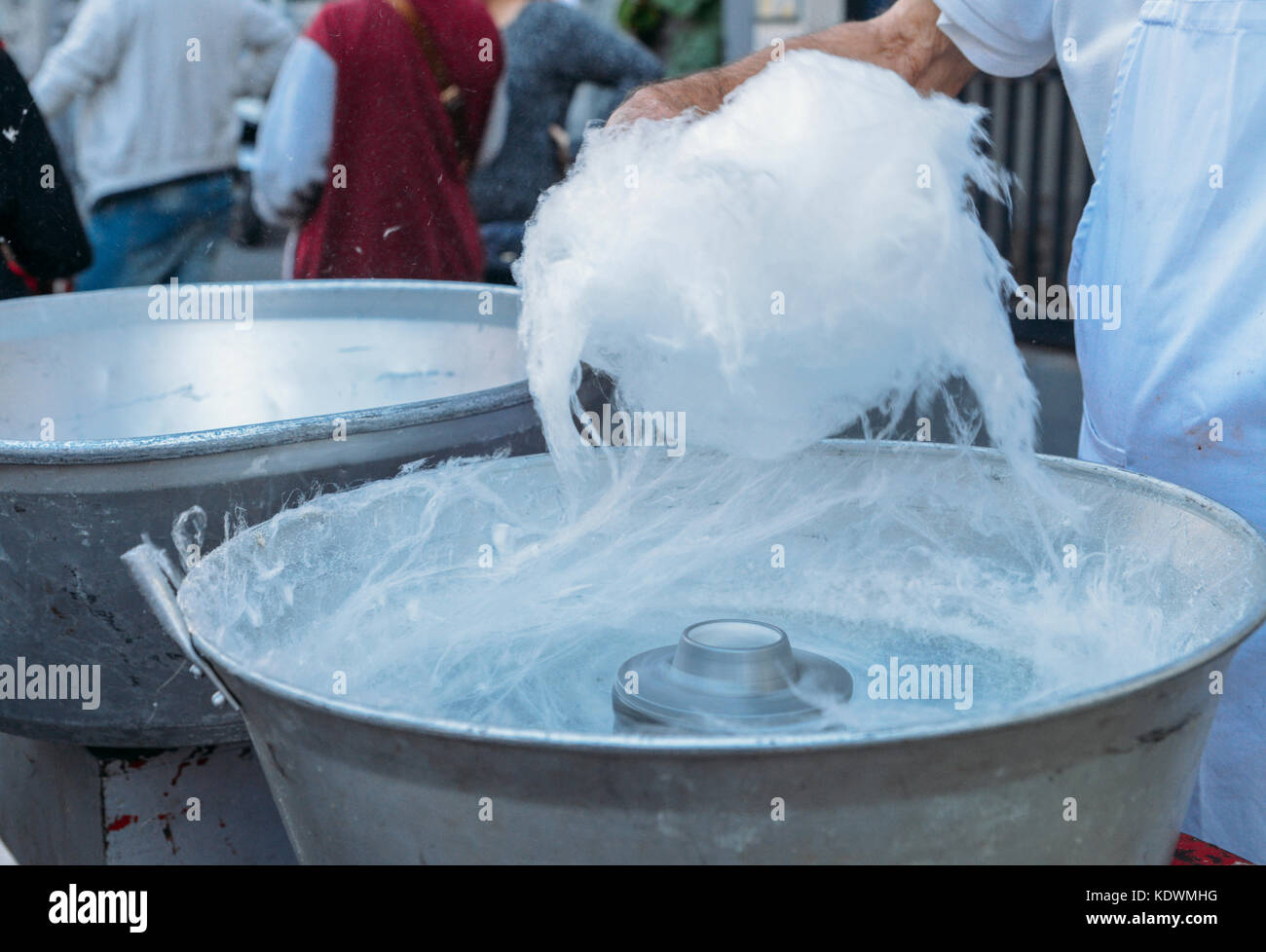 Close up of person making cotton candy, a sugary snack at a fair Stock Photo