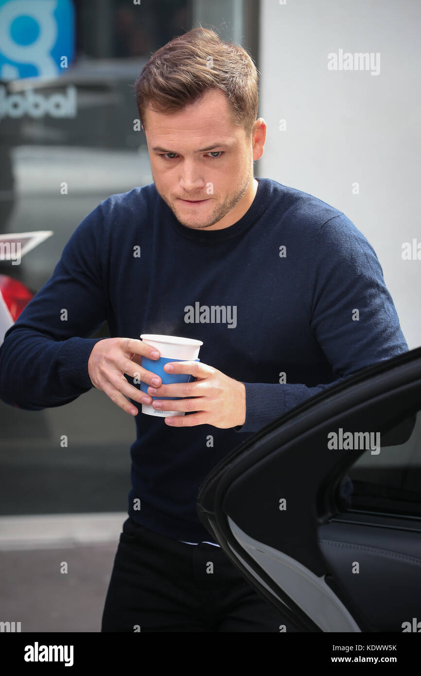 Taron Egerton leaving Global Radio Studios after promoting his new film  'Kingsman The Golden Circle'. Taron was trying not to spill his coffee as  he made his way to his car and