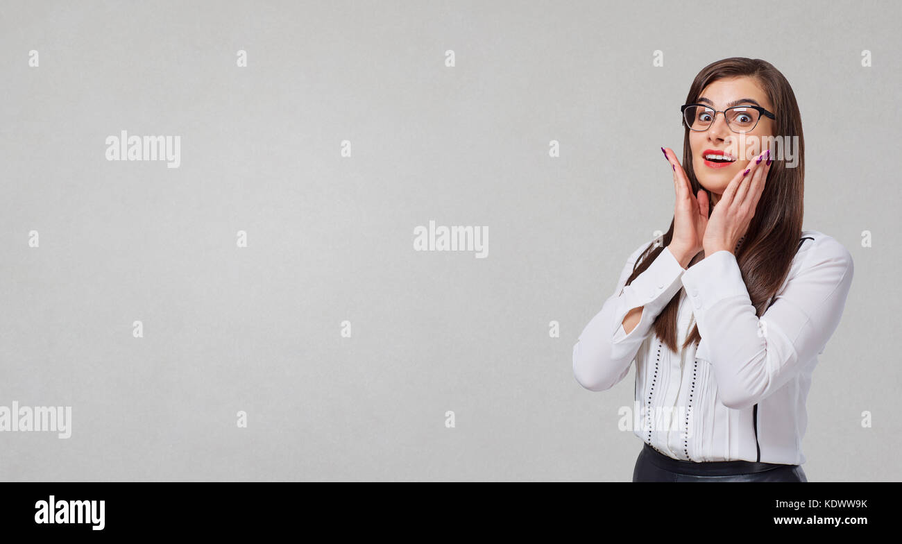 Businessman with surprised emotions on a gray background.  Stock Photo