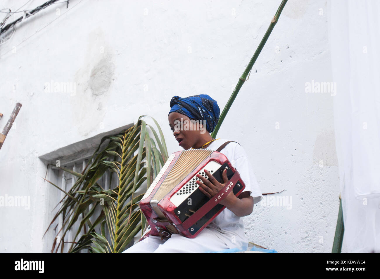 A female accordion player sings during the Sauti za Busara music