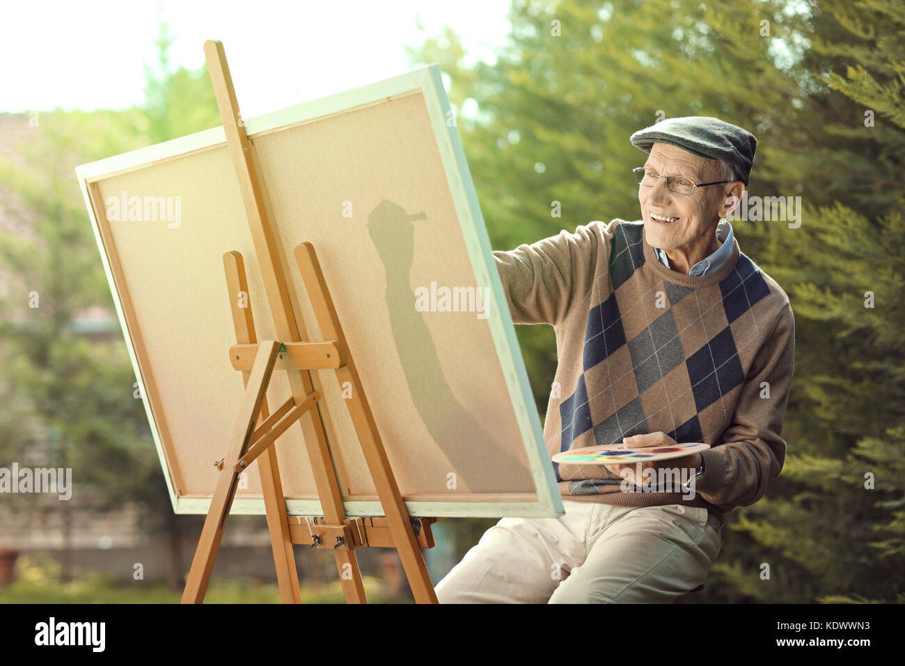 Seated man painting hi-res stock photography and images - Alamy