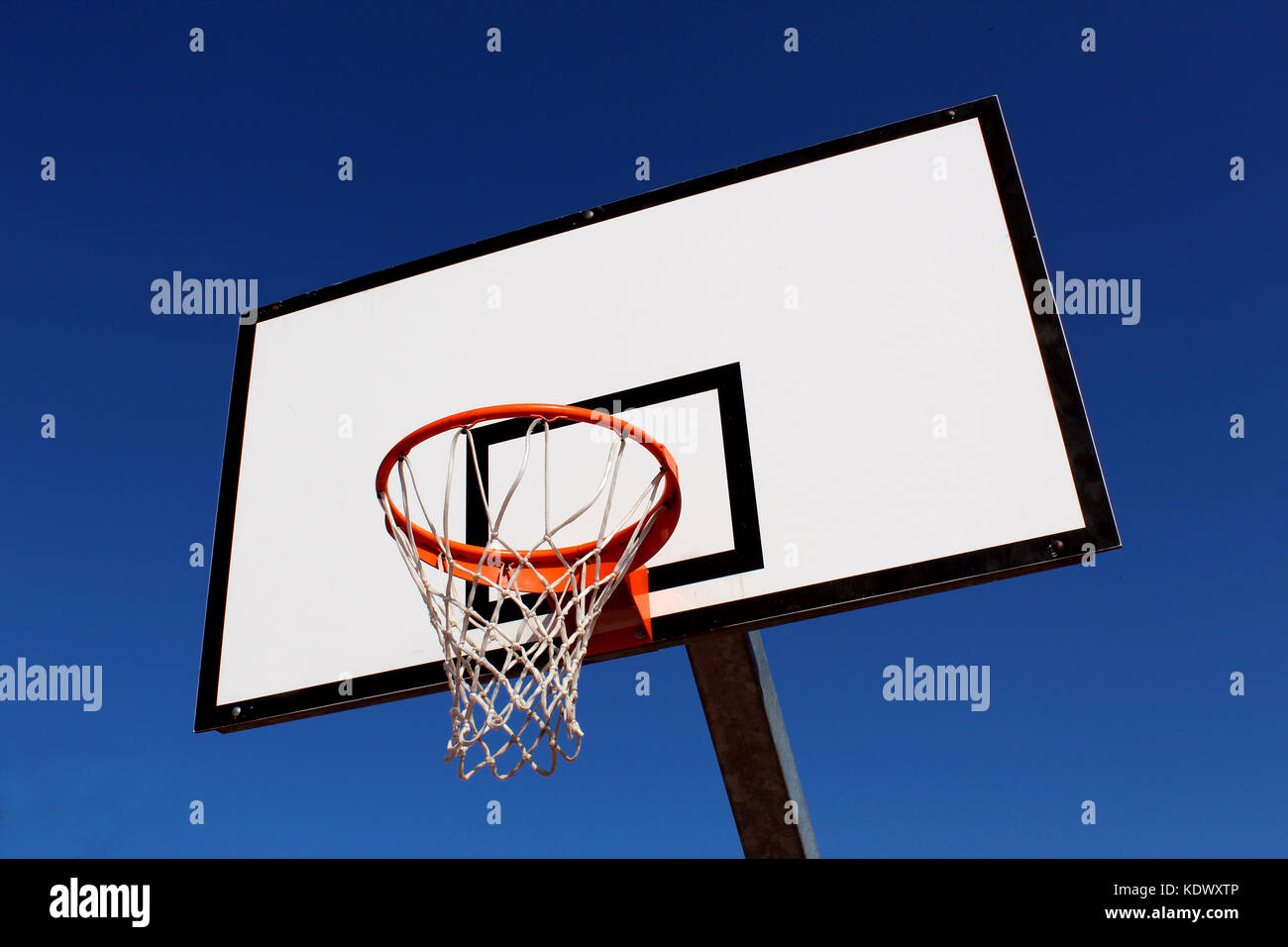 Basketball hoop against blue sky in a playground Stock Photo