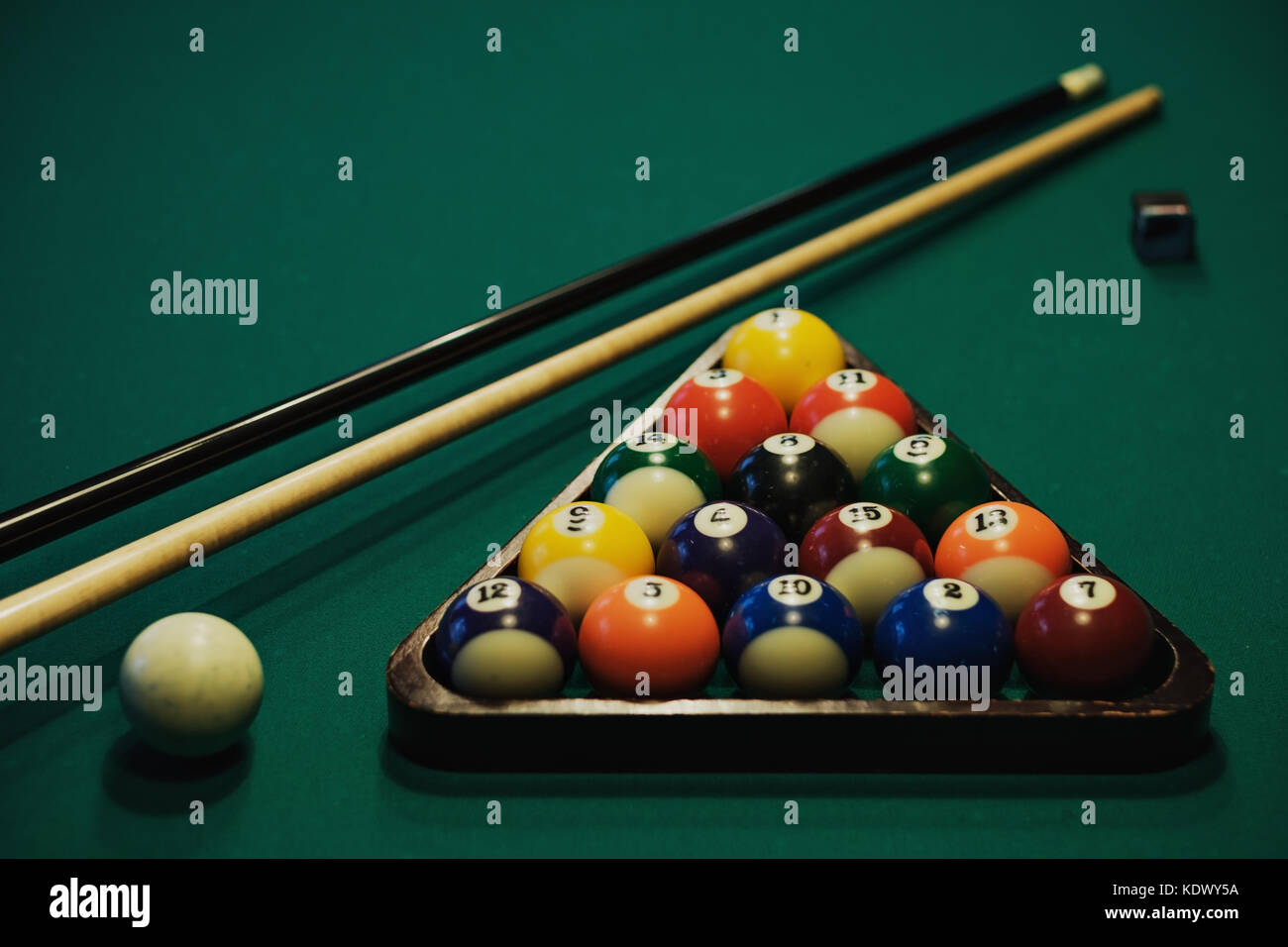 Playing billiard. Billiards balls and cue on green billiards table