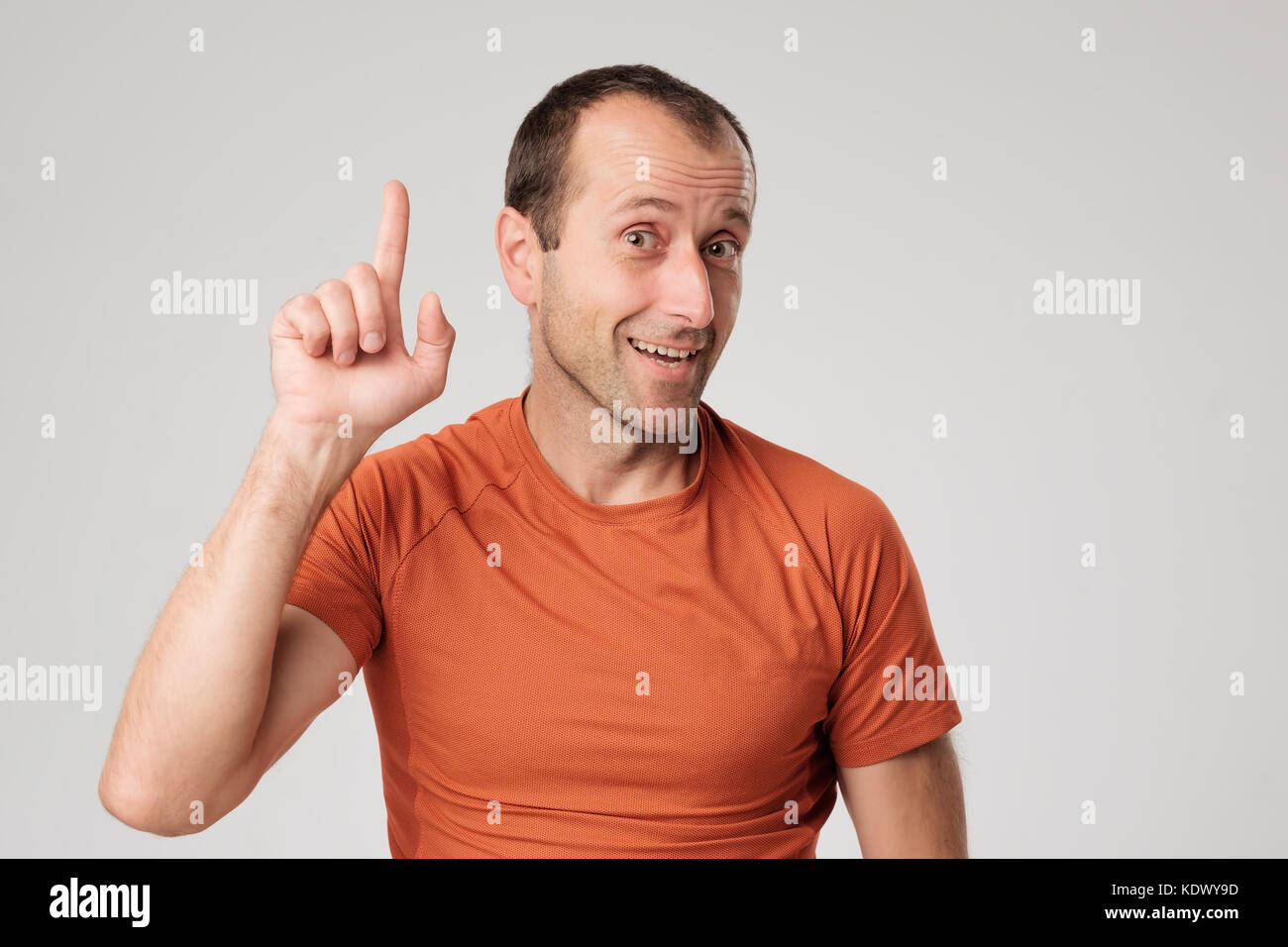 Mature hispanic man showing upwards index finger. Stock Photo